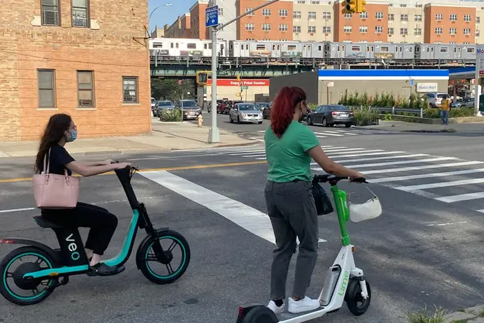 Two Bronxites taking their first electric scooter rides on Tuesday